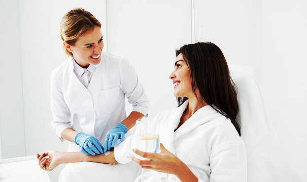 nurse setting up iv drip to the patient