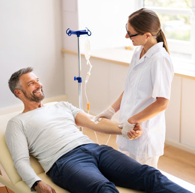 nurse setting up iv drip